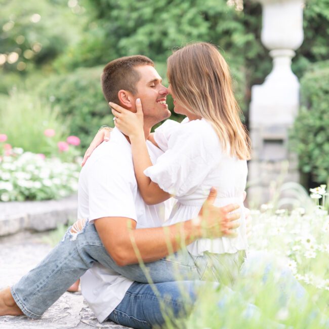 Couple embracing on a garden bench among flowers